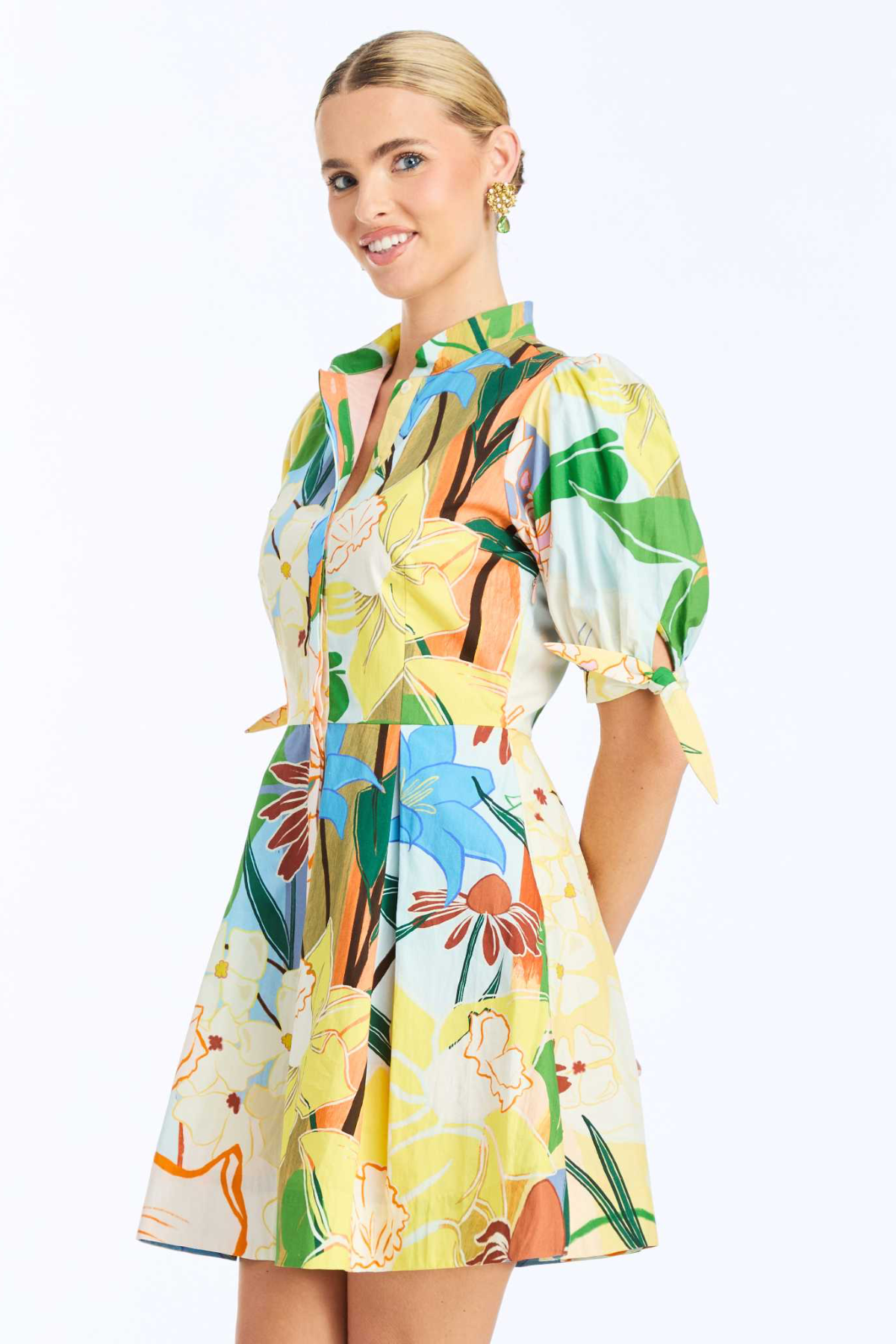 Woman wearing a colorful floral dress on a white background