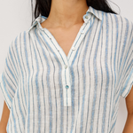 Close-up of a person wearing a blue and white striped shirt against a white background