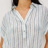 Close-up of a person wearing a blue and white striped shirt against a white background