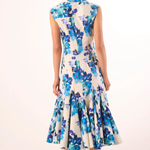 Woman wearing a floral dress with a white background