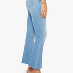 Light blue jeans worn by a person on a white background