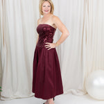 Burgundy sequin dress for evening wear paired with heels