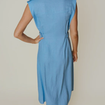 back of woman in blue midi dress on an background 