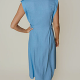 back of woman in blue midi dress on an background 