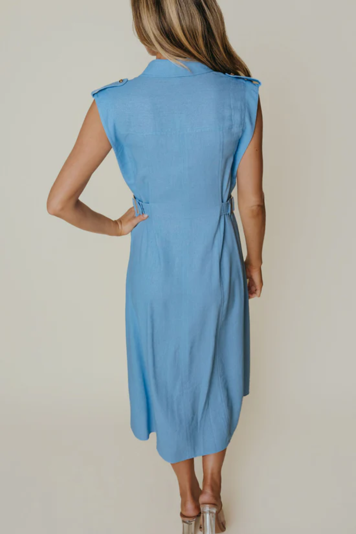 back of woman in blue midi dress on an background 