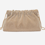 A small drawstring clutch bag with a textured, woven metallic mesh body in a champagne gold color, shown against a plain light gray background.