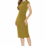 A woman modeling a knee-length olive green dress with cap sleeves and a gathered waist detail, paired with dark pointed-toe heels, against a plain white background.