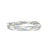 Multistrand beaded bracelet with gold accents on a white background