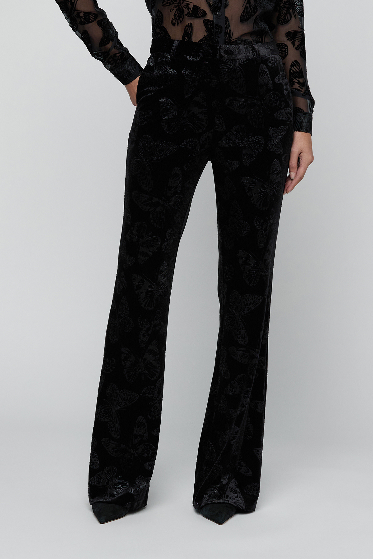 Black trousers on a gry background.