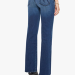 Rear view of a model wearing blue denim jeans with a distinctive 'M' logo on the back pocket, paired with black high-heeled boots against a light gray background.