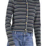 A woman wearing a navy blue ribbed knit cardigan with thin cream and white horizontal stripes, featuring gold buttons down the front, paired with blue jeans.