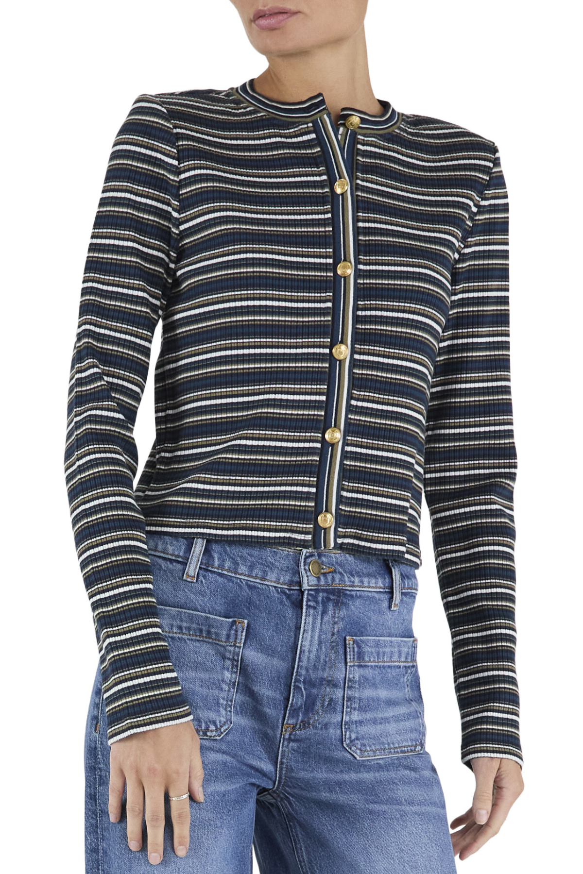 A woman wearing a navy blue ribbed knit cardigan with thin cream and white horizontal stripes, featuring gold buttons down the front, paired with blue jeans.