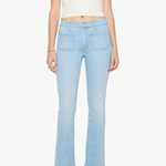 woman in blue flare denim on white background 