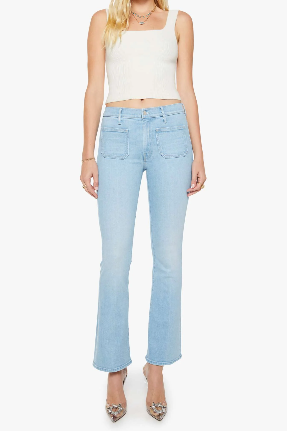 woman in blue flare denim on white background 