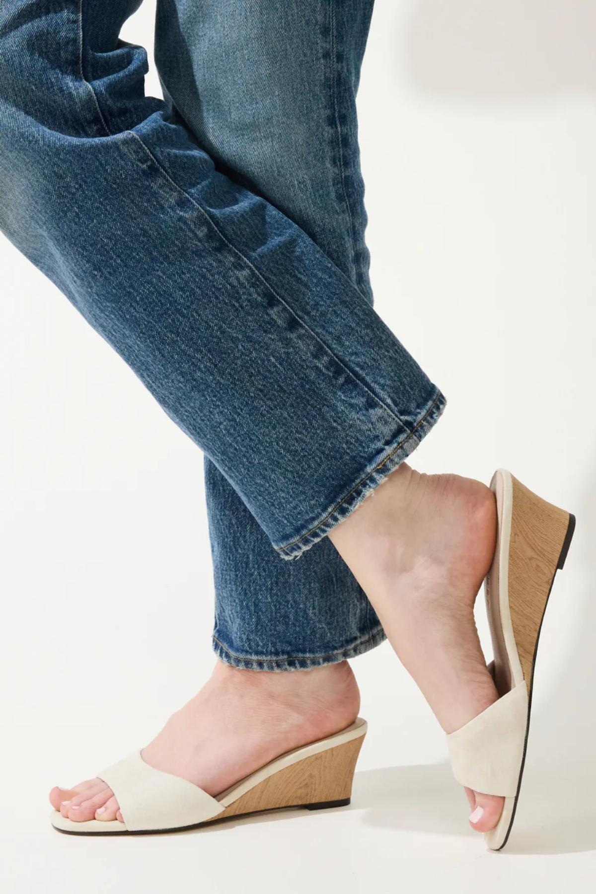 woman in white wedges on white background 