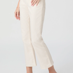 Person wearing white pants and white flats on a light gray background