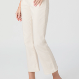Person wearing white pants and white flats on a light gray background