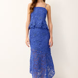 Woman wearing a blue lace dress on a white background