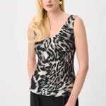 Woman wearing a sleeveless animal print top against a white background