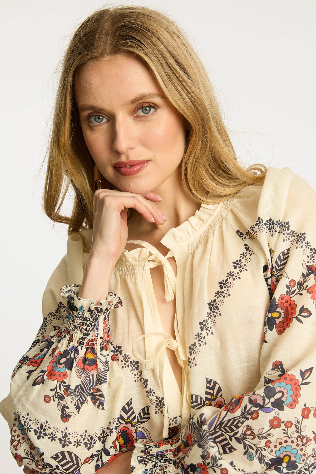 Neutral blouse with a streamlined, polished silhouette.
