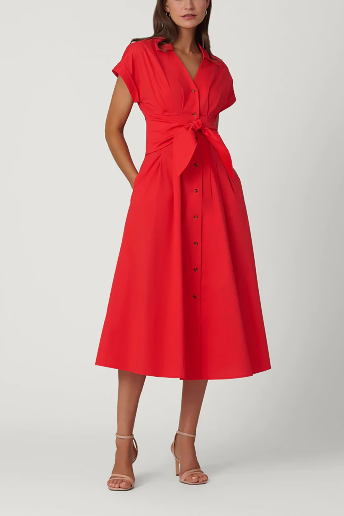 Woman wearing a red dress with a belt on a white background