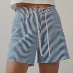 woman in drawstring stripe denim shorts on white background 