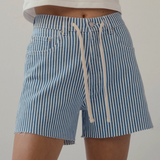 woman in drawstring stripe denim shorts on white background 