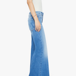 Person wearing blue flared jeans on a white background