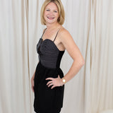 Black sleeveless bustier dress with top-stitch detailing, styled against a clean backdrop