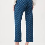Person wearing blue patterned pants on a white background