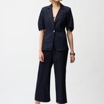 Woman wearing a navy blue suit on a white background