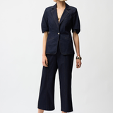 Woman wearing a navy blue suit on a white background