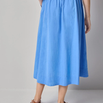 back of woman in blue cotton maxi skirt 