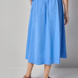 back of woman in blue cotton maxi skirt 