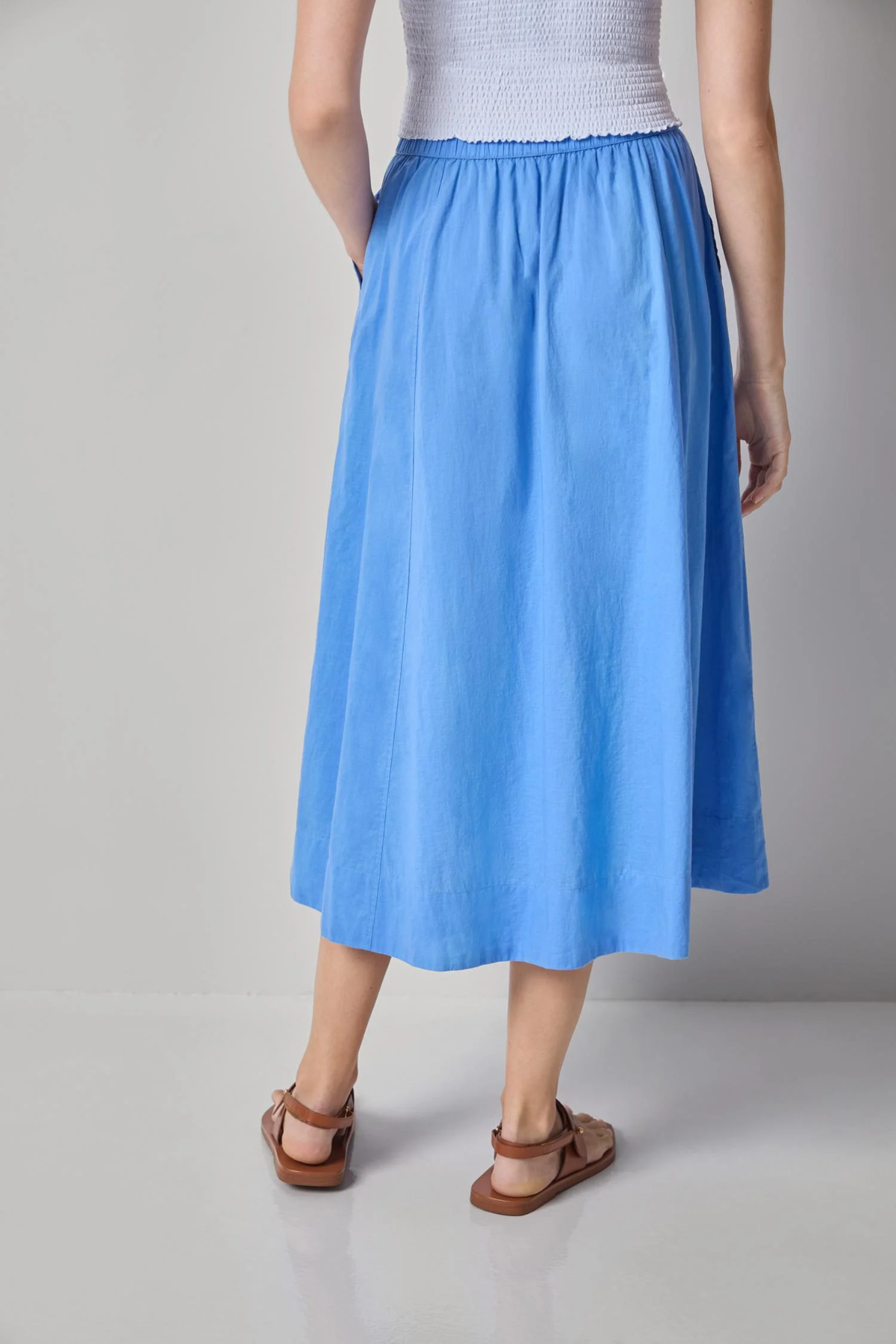 back of woman in blue cotton maxi skirt 