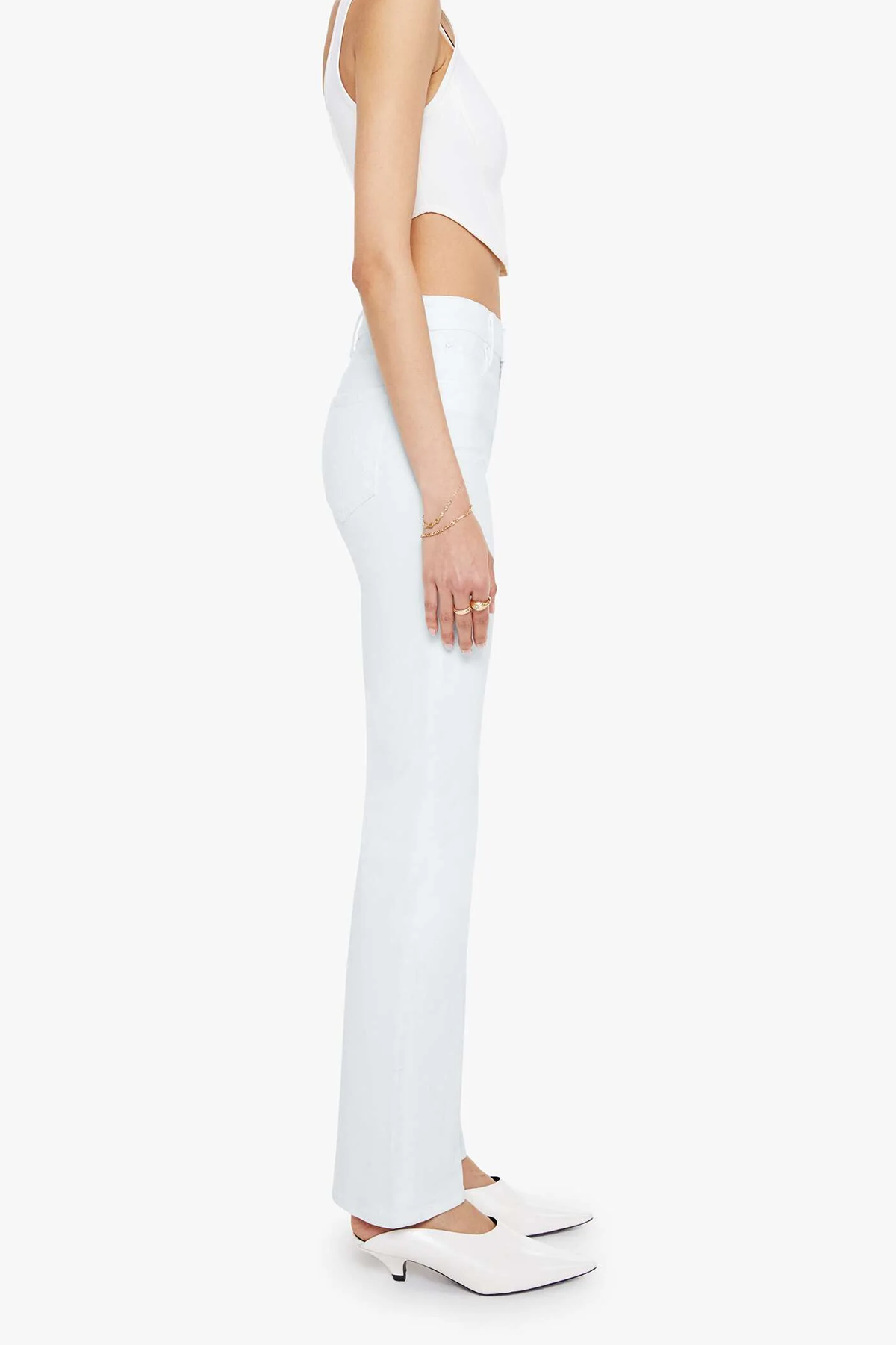 Person wearing a white outfit with high-waisted pants on a white background