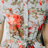 Floral dress with red and green flowers on a light background