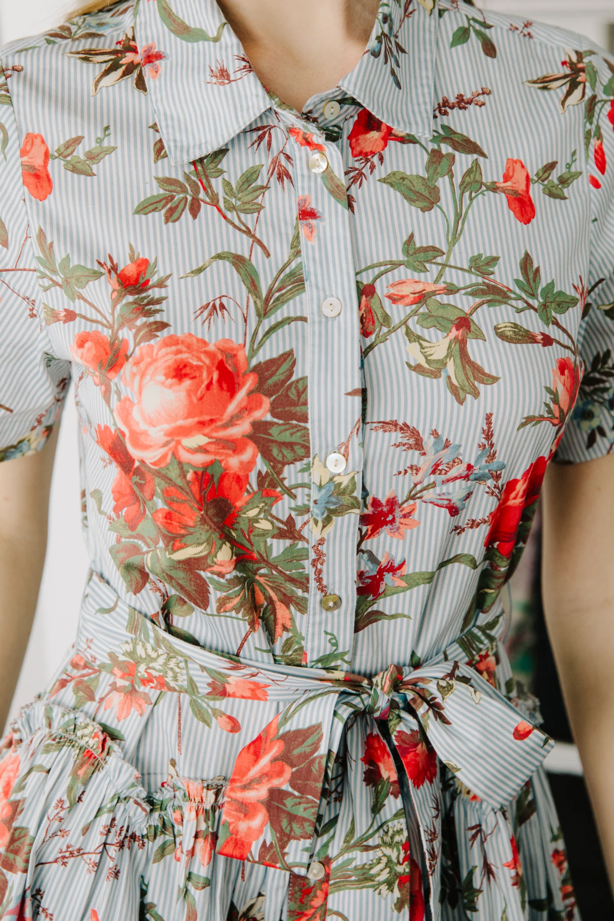 Floral dress with red and green flowers on a light background