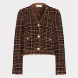 A cropped tweed jacket in a brown and black plaid pattern with gold buttons, displayed on a neutral light gray background.