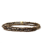Three brown beaded bracelets on a white background