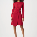 Woman wearing a red dress with a belt on a white background