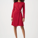 Woman wearing a red dress with a belt on a white background