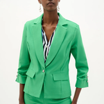 Woman wearing a bright green suit with a white background