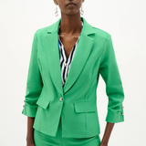 Woman wearing a bright green suit with a white background