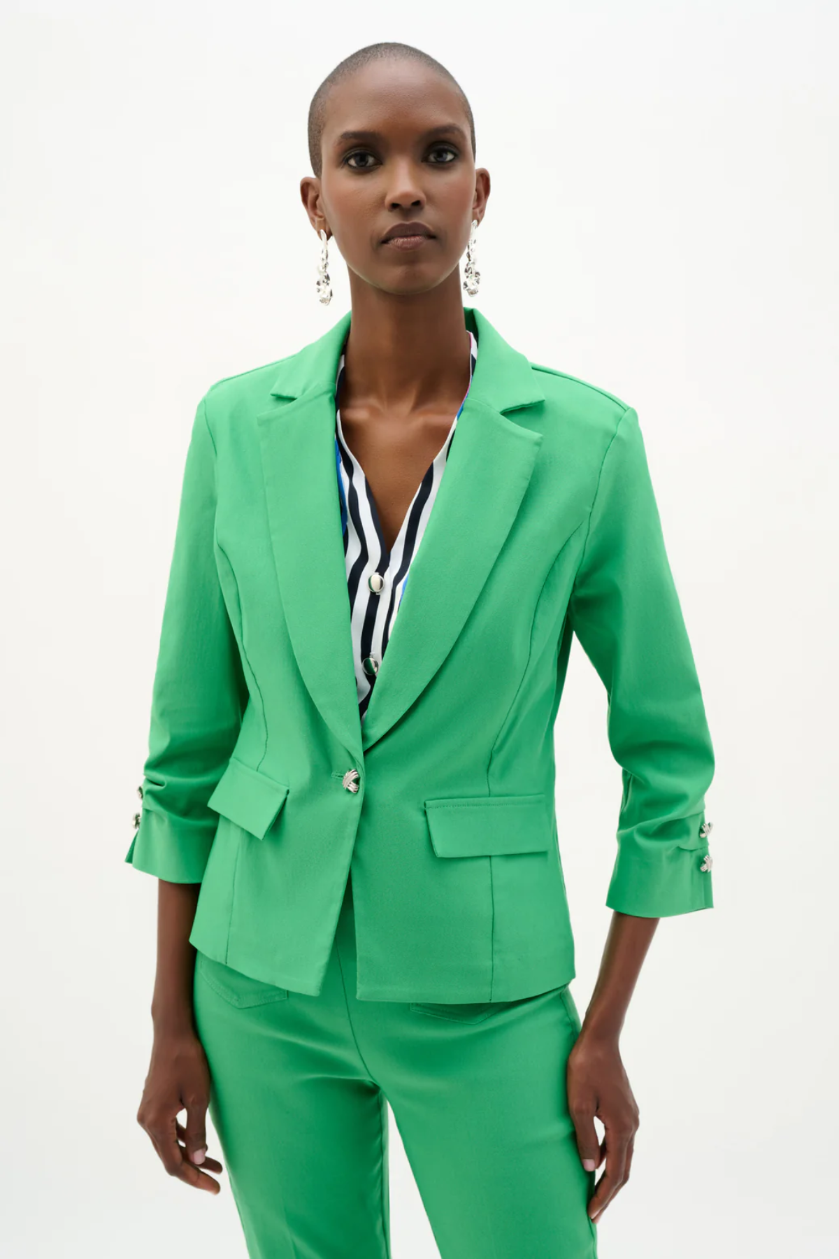 Woman wearing a bright green suit with a white background