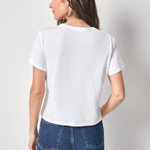Woman wearing a white t-shirt and blue jeans against a plain background