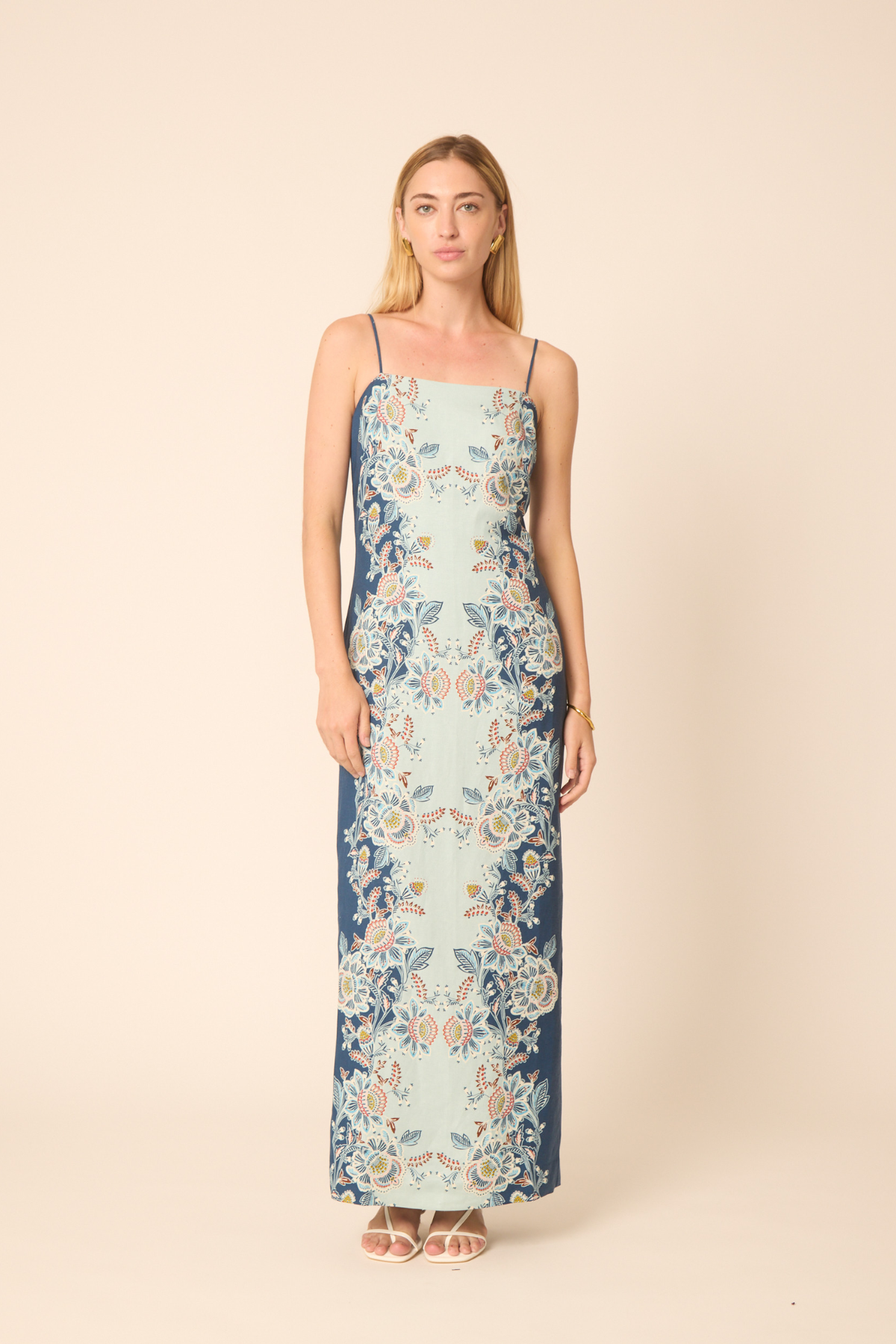 Woman wearing a floral dress on a beige background