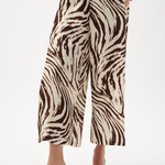 Zebra print pants worn by a person on a white background