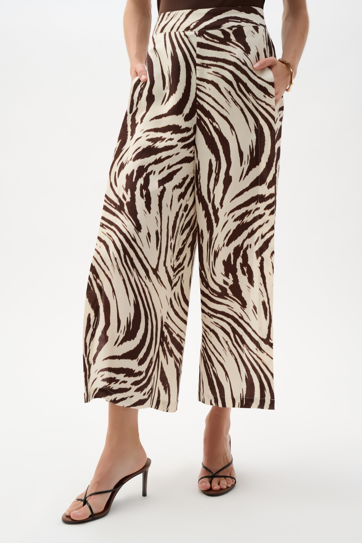 Zebra print pants worn by a person on a white background