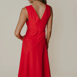 Red dress with a V-neckline on a plain background